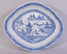 A CHINESE BLUE AND WHITE PORCELAIN DISH, the centre painted with a landscape scene, 26.5cm x 22cm.