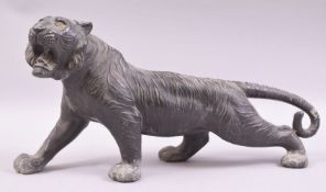 A JAPANESE BRONZE MODEL OF A TIGER, in a predatory stance, 43cm long.