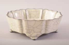 A CHINESE SONG STYLE GE WARE BRUSH WASHER BOWL, the base with calligraphy, raised on four feet, 17.