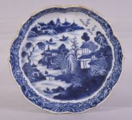 A CHINESE BLUE AND WHITE PORCELAIN TRAY, painted with a river landscape including buildings, figures