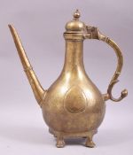 AN 18TH CENTURY MUGHAL BRASS EWER, raised on four brass feet, 33cm high.
