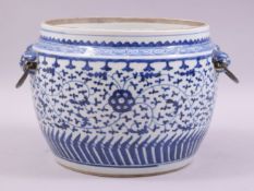 A CHINESE BLUE AND WHITE PORCELAIN BOWL, with twin mask and wire work handles, the body painted with