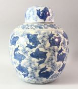 A LARGE CHINESE BLUE AND WHITE PORCELAIN JAR AND COVER, profusely decorated with fish, 37cm high