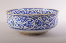 A TURKISH OTTOMAN IZNIK BLUE AND WHITE GLAZED POTTERY BOWL, decorated with bands of intertwined
