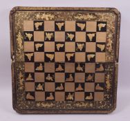 A VERY GOOD 19TH CENTURY GILT AND LACQUERED FOLDING CHESS BOARD, interior with backgammon board,