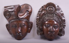 A PAIR OF BEAUTIFULLY CARVED WOODEN INDONESIAN MASKS of a male and female with head dress, the