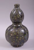 AN UNUSUAL CHINESE FAMILLE NOIR GOURD VASE, baring the symbol of longevity and decorated with a