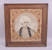 A WOOLWORK TAPESTRY BUST LENGTH PORTRAIT of a male Arab youth in a moulded oak frame, image size