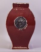 A CHINESE SANG DE BOEUF VASE, with calligraphic roundel to one side, 29cm high.