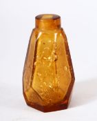 A CHINESE AMBER GLASS & GOLD FLAKE SNUFF BOTTLE, of tapering hexagonal form.