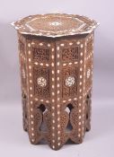A MOORISH OCTAGONAL BONE INLAID AND CARVED TABLE, 32cm diameter, 49cm high.