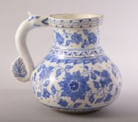 A TURKISH OTTOMAN IZNIK BLUE AND WHITE MASRAPA WATER JUG, painted with scrolling foliate decoration,