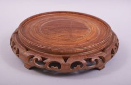A GOOD CHINESE WOODEN STAND, the centre with a space of 15cm diameter, overall diameter 19.5cm.