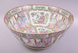 A LARGE CHINESE CANTON PORCELAIN PUNCH BOWL, painted with panels of figures, birds and native flora,