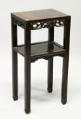 A CHINESE HARDWOOD RECTANGULAR TWO TIER URN STAND, with pierced and carved frieze, on square legs,