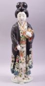 A JAPANESE KUTANI PORCELAIN FIGURE, modelled as a standing female figure holding two books, 45cm