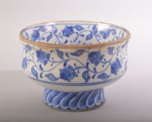 A TURKISH IZNIK BLUE AND WHITE GLAZED POTTERY PEDESTAL BOWL, painted with scrolling foliate