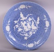 A LARGE CHINESE MOTTLED BLUE GLAZED AND INCISED DISH, the dish with carved decoration depicting