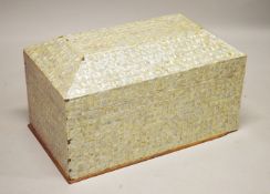 A LARGE INDIAN MOTHER OF PEARL VENEERED SARCOPHAGUS SHAPED COFFER, the hinged cover revealing a