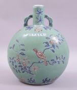 A CHINESE TURQUOISE GROUND BLUE AND IRON RED UNDERGLAZE TWIN HANDLE MOON FLASK, decorated with birds