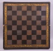 A CHINESE LACQUER AND GILT FOLDING CHESS BOARD, the interior with a backgammon board, 50cm wide.