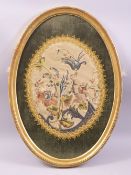 A CHINESE OVAL SILK WORK PICTURE, embroidered with a floral bouquet, framed and glazed, overall 55cm