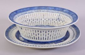 A CHINESE BLUE AND WHITE PIERCED PORCELAIN BASKET AND TRAY, the central interior painted with a