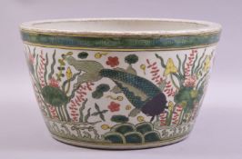 A LARGE CHINESE FAMILLE VERTE JARDINIERE, painted with fish and aquatic flora, 31cm diameter.