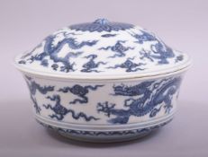 A CHINESE BLUE AND WHITE PORCELAIN BOWL AND COVER, decorated with dragons amongst stylised clouds,