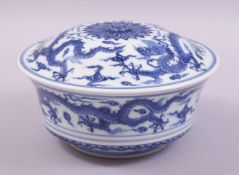 A CHINESE BLUE AND WHITE PORCELAIN BOWL AND COVER, decorated with dragons amongst stylised clouds,