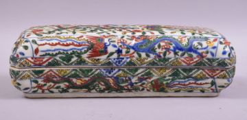 A LARGE CHINESE DOUCAI PORCELAIN PEN BOX, painted in the douci palette with multiple dragons and