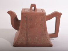 A CHINESE YIXING TEAPOT, with script to one side and mark to inner lid and base, 12.5cm high.