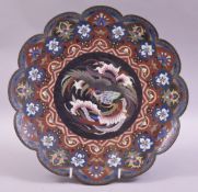 A JAPANESE CLOISONNE PETAL FORM DISH, the centre with a roundel containing a stylised cockerel, 30cm