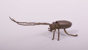 A JAPANESE BRONZE MODEL OF A LONG HORNED BEETLE, with hinged back, 14.5cm long.