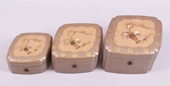A GRADUATED SET OF THREE JAPANESE SHIBIYAMA DECORATED LACQUER BOXES, diamond shaped, each with