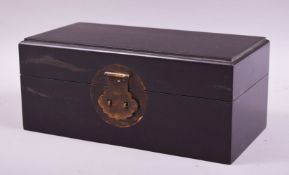 A CHINESE RECTANGULAR HINGED LIDDED WOODEN BOX, with brass pin lock (lacking pin), 11cm high, 26cm