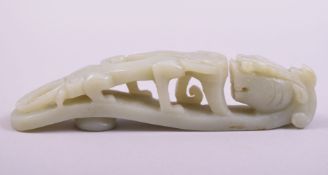 A CHINESE CARVED JADE DARGON FORMED BUCKLE, 14cm long.