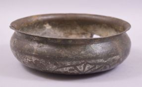 A 17TH CENTURY ISLAMIC SILVER INLAID COPPER CIRCULAR BOWL, with floral inlay and calligraphic