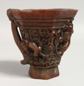 A LARGE CARVED HORN LIBATION CUP.