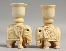 A PAIR OF CARVED BONE ELEPHANT CANDLESTICKS. 3.5ins high.