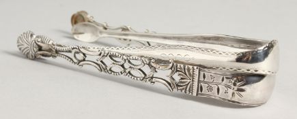 TWO GEORGE III SUGAR TONGS. Circa. 1800, maker W T & A and a pierced one.