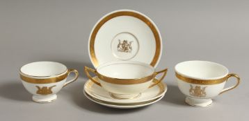 TWO MINTON CUPS of different design and three matching saucers, gilded with the Coat of Arms of