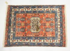 A PERSIAN ARDABIL RUG, rust ground with stylised design all over. 5ft 3ins x 3ft 11ins.
