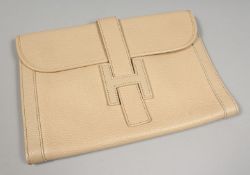 A CREAM LEATHER CLUTCH BAG. 11ins x 7.75ins.