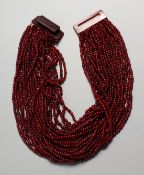 A GERAD LYNGANRD FOR MONIES, HORN NECKLACE in a white bag