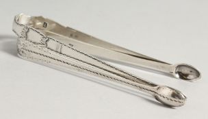 TWO GEORGE III BRIGHT CUT SUGAR TONGS, Circa.1800, maker T T & maker R C