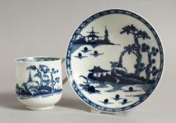 AN 18TH CENTURY WORCESTER COFFEE CUP AND SAUCER painted in blue with an island house, a rock and two