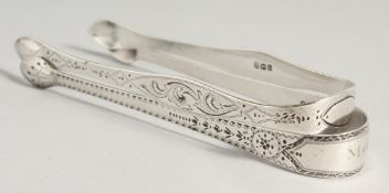 TWO GEORGE III BRIGHT CUT SUGAR TONGS. London 1802, maker Peter, Ann and William Bateman & London