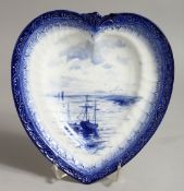 A ROYAL CROWN DERBY HEART SHAPED DISH, painted with an estuary scene in blue, by W E J DEAN.