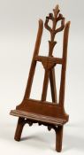A MINIATURE WOODEN FOLDING EASEL. 11ins high.